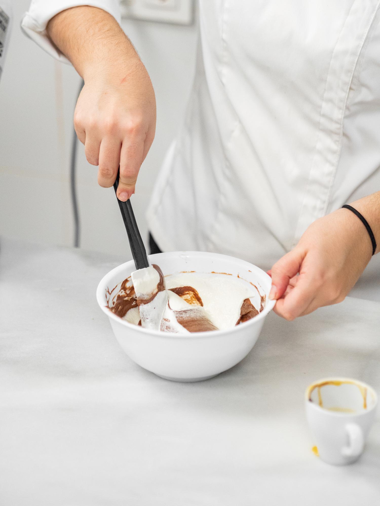 Pastry chef frosting dessert